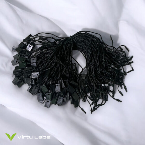 black hang tag string on white fabric background