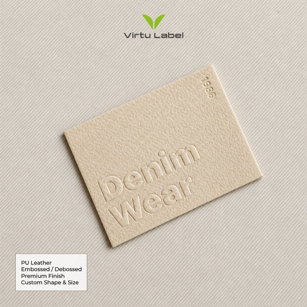 Cream PU leather patch with embossed denim wear logo and textured finish