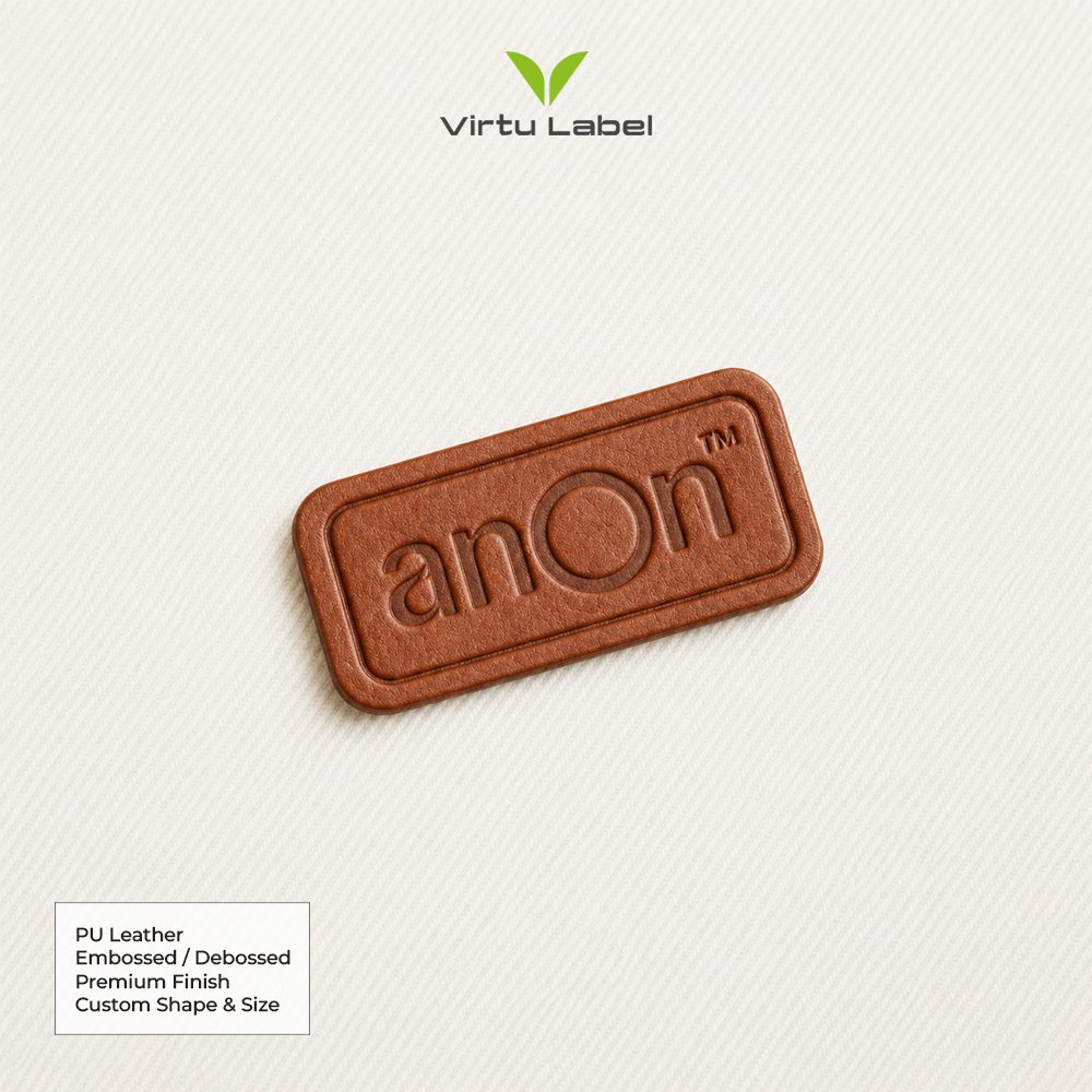Brown PU leather patch with embossed Anon logo and rounded rectangular design