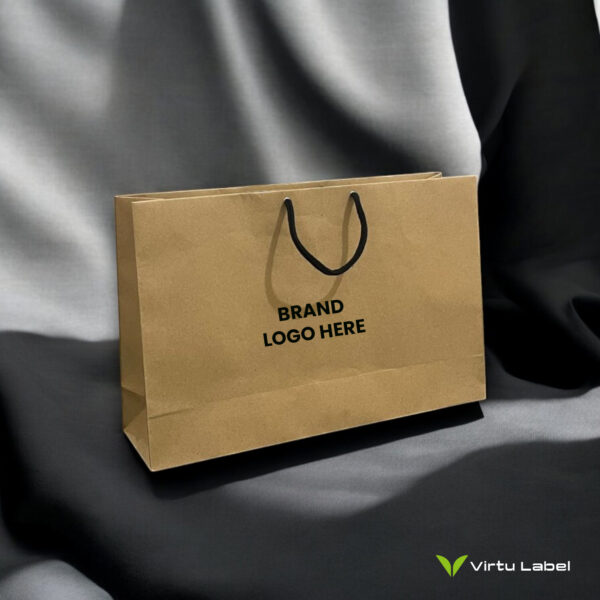 brown paper bag with black string on grey fabric