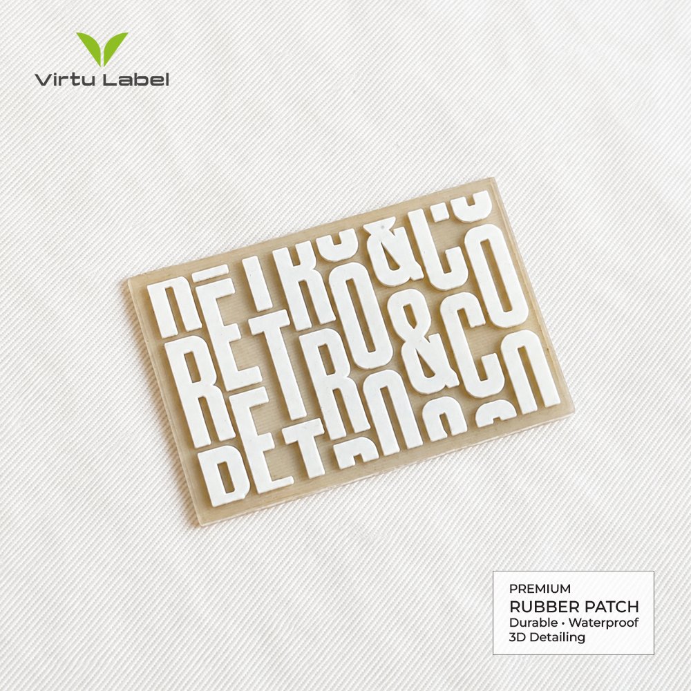 Custom rectangular rubber patch with raised white RETRO&CO lettering on a beige PVC base
