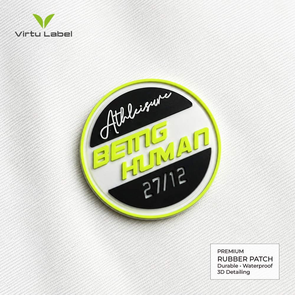 Custom round rubber patch with neon yellow border, raised Athleisure and Being Human lettering