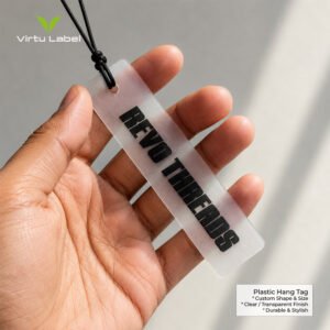 Premium clear plastic hang tag with custom black lettering held by hand